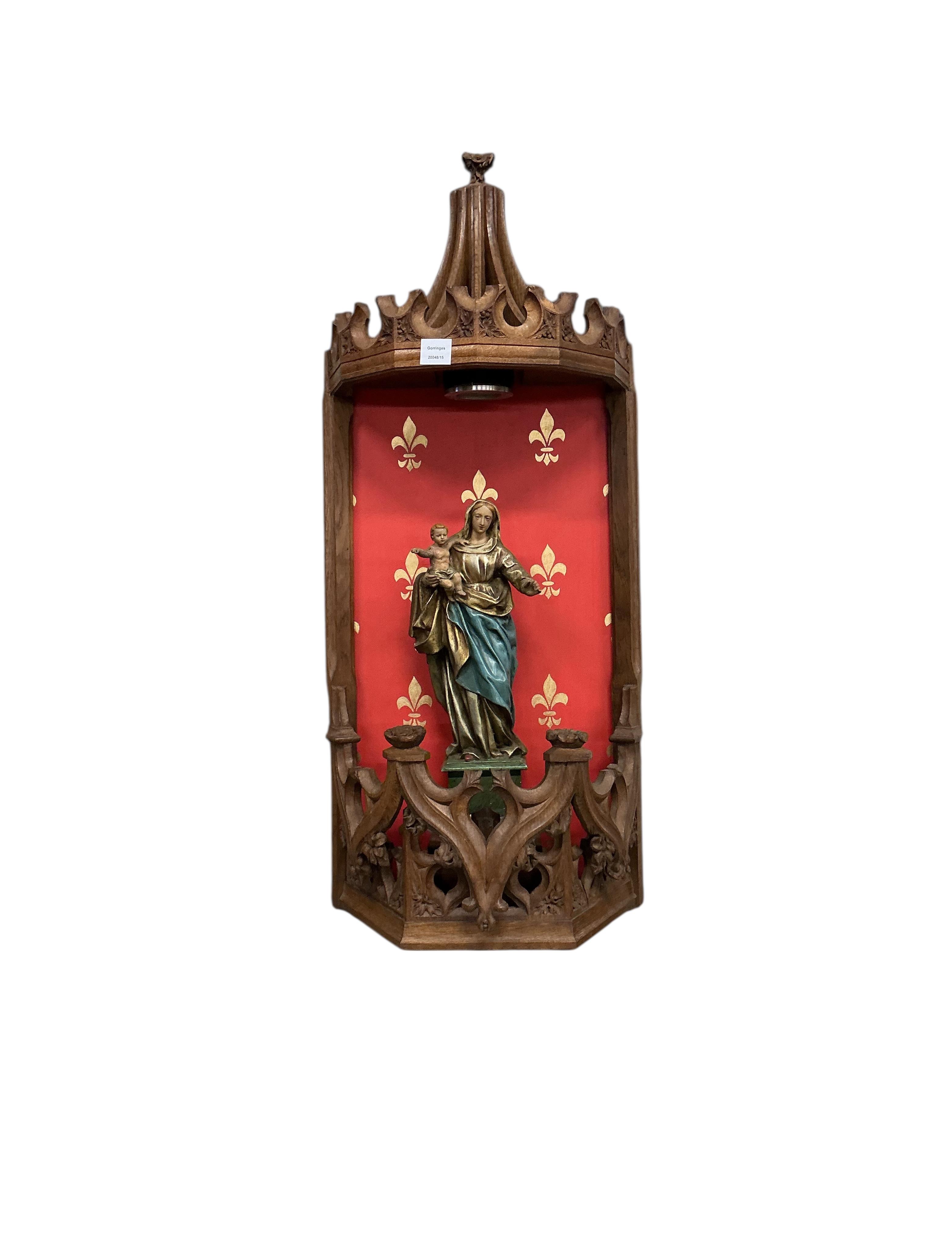 A Gothic Revival carved oak niche with plaster Madonna and child, height 104cm